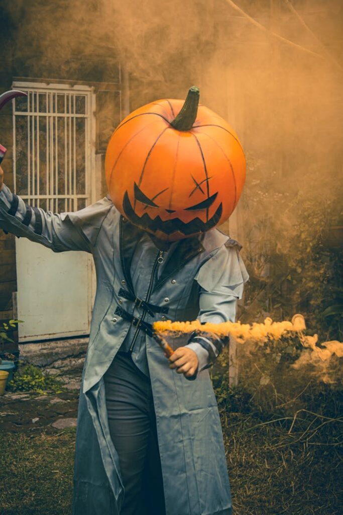 Creative pumpkin head cosplay in outdoor Halloween setting, showcasing scary costume and smoke effects.